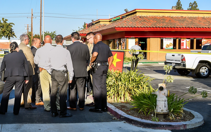 Covina police and detectives investigating shooting that happened inside Carl Jr. and Green Burrito building in Covina. An off-duty Los Angeles Police Department reserve officer fatally shot a man who tried to rob him at gunpoint inside a fast-food restaurant, officials said.The shooting occurred Wednesday, July 6, 2016 at Carls Jr., 573 N. Azusa Ave., Covina police and Los Angeles County Fire Department officials said. The off-duty reserve officer had stopped in for lunch when a suspected gunman approached and apparently tried to rob him, Covina police Sgt. Gregg Peterson said. The preliminary investigation revealed the suspect brandished a weapon at the off-duty officer, who then shot the suspect in the upper torso, Peterson said. The sergeant said the suspect was struck multiple times.Paramedics pronounced the wounded man dead at the scene, according to fire department Dispatch Supervisor Melanie Flores.His identity was not available pending positive identification and notification of family members, authorities said.Covina police are handling the investigation into the incident. The name of the involved off-duty LAPD officer was not released Wednesday.(Photo by Walt Mancini/Pasadena Star-News)