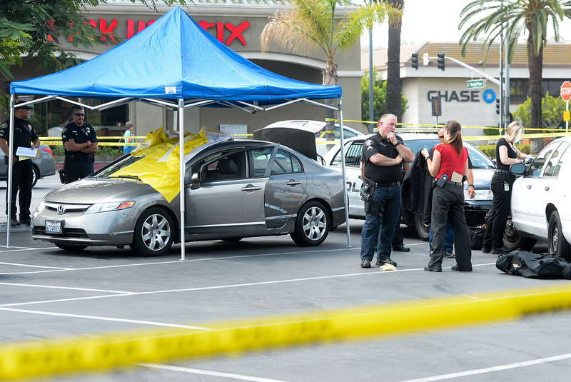 La Habra Police and Orange County Coroner's Investigators examine the car where the body of a woman in her mid-30's was found in the parking lot on the West 1200-block of Imperial Highway in La Habra on Friday August 5, 2016. (Photo by Keith Durflinger/Whittier Daily News)