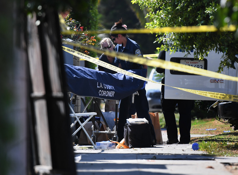 A body is removed by the Los Angeles County coroner staff after three people were killed during a shooting after a dispute at a pop-up Jamaican restaurant in Los Angeles on October 15, 2016 Three people were killed and at least a dozen more injured, police said Saturday. One person has been arrested and police have launched a manhunt for another in connection with the deadly incident in West Adams, in the southwestern part of the metro area, said spokesman Lieutenant Chuck Springer.   / AFP / Mark RALSTON        (Photo credit should read MARK RALSTON/AFP/Getty Images)