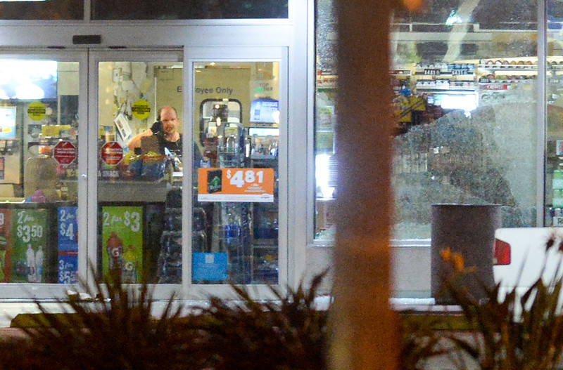 The robbery suspect stands inside by himself with a shot up window as Los Angeles County Sheriff's deputies surround an AMPM Arco gas station on Beach Boulevard at Hillsborough Drive in La Mirada on Monday November 21, 2016. (Photo by Keith Durflinger/Whittier Daily News/SCNG)