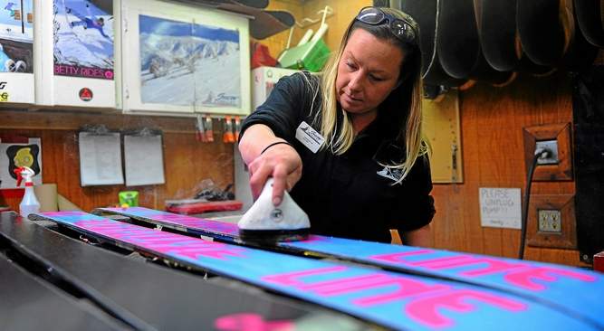 Theresa McCrackn waxes skis on Tuesday at Snow Valley Resort in Running Springs. Tuesday was the resort's opening day for the winter. (Photo by LaFonzo Carter/San Bernardino Sun)