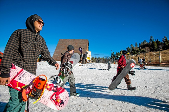 Snowboarders look to head up the chairlift at Bear Mountain Resort in Big Bear Lake, Friday, November 28, 2014. California is suffering  one of the worst droughts in its history. (Eric Reed/For the Sun)