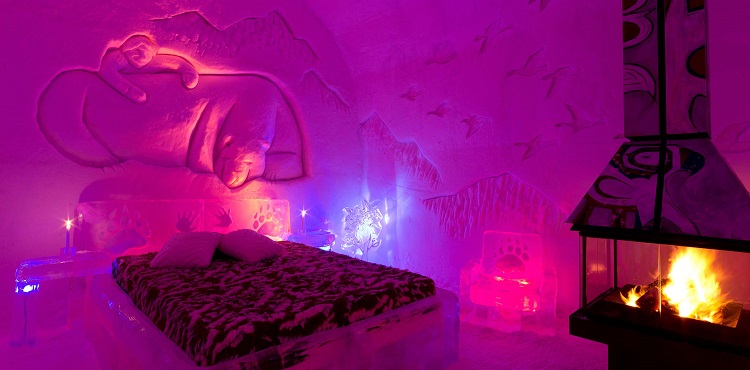 The Hotel de Glace in Quebec features guestrooms with elaborate carved walls and a bed made of ice. Some, like this one, come with a fireplace, though it's only for looks - no heat enters the room. (Photo courtesy Hotel de Glace)