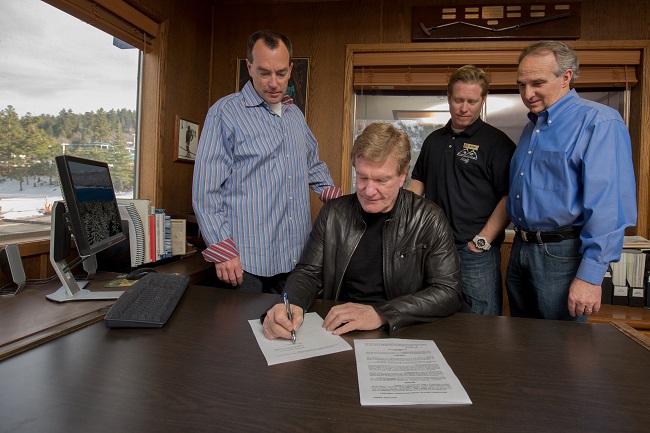 Rusty Gregory signing agreement. 