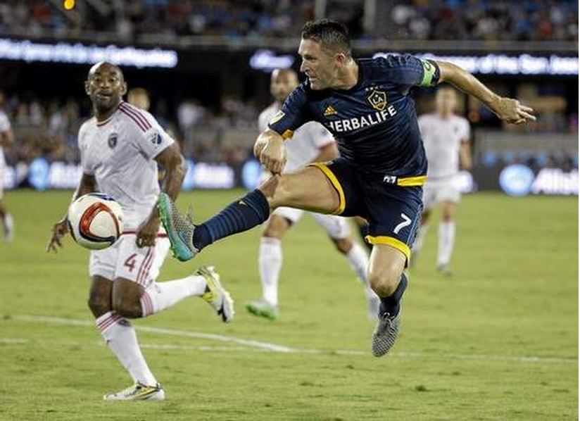 Galaxy forward Robbie Keane takes a shot on goal as San Jose defender Marvell Wynne watches Friday in San Jose. (Marcio Jose Sanchez/The Associated Press) 