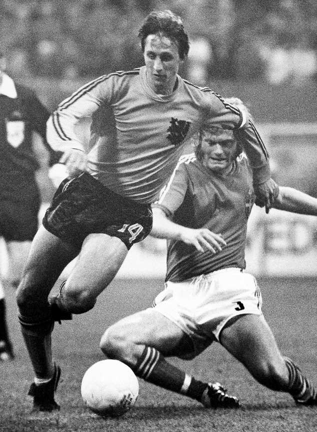 FILE - In This June 19, 1974 file photo, Netherlands Johan Cruyff, left, dodges the tackle from Sweden's Kent Karlsson during a World Cup soccer match  in Dortmund, Germany. Dutch soccer great Johan Cruyff, who revolutionized the game with the concept of 'Total Football,' died Thursday March 24, 2016. He was 68. (AP Photo/File)