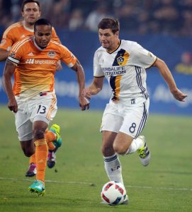 Steven Gerrard, who scored the winning goal in Friday's 1-0 victory against Houston, makes a run against Ricardo Clark. (Will Lester/SCNG-Inland Valley Daily Bulletin)