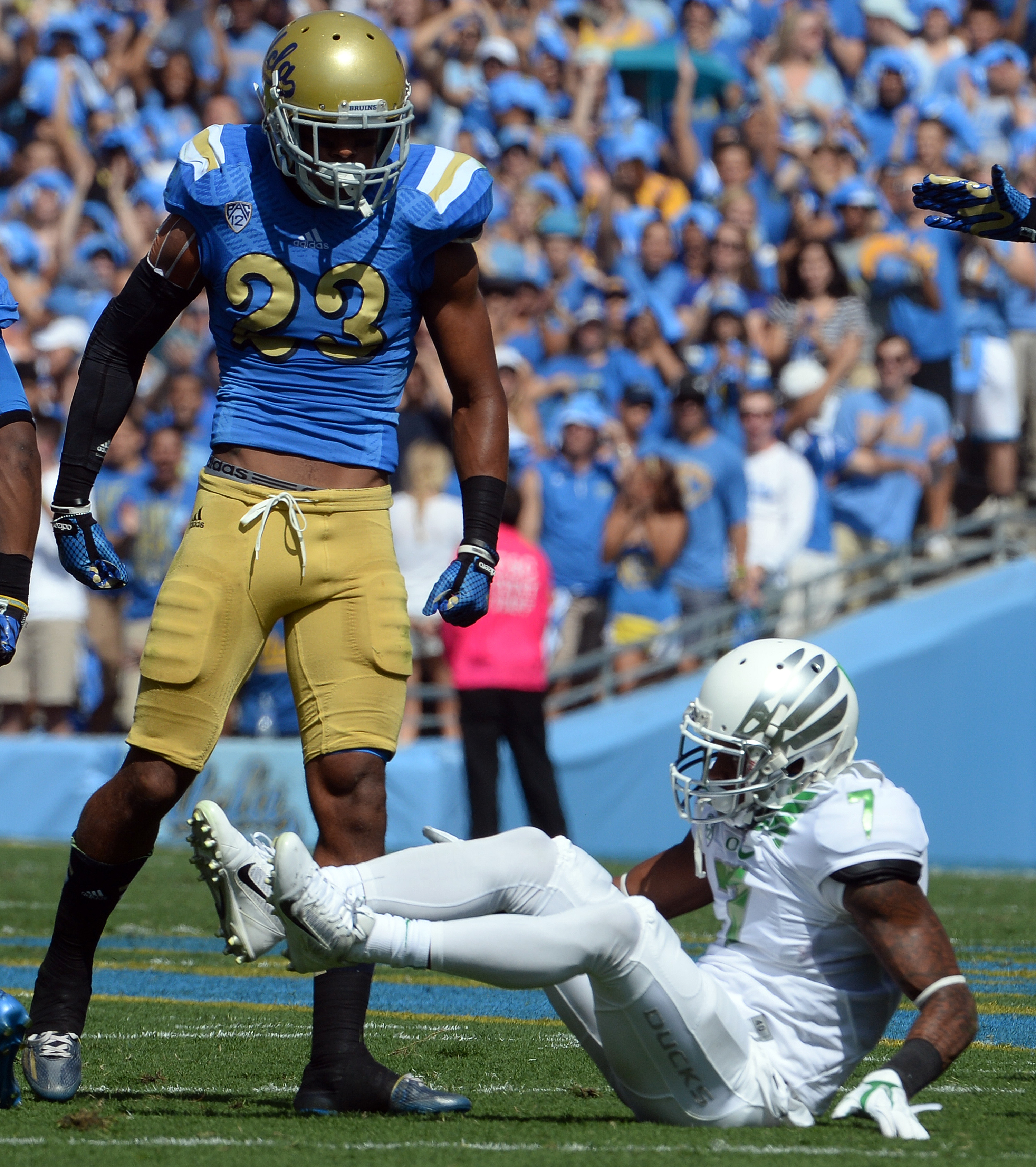 UCLA defensive back Anthony Jefferson stands over Oregon receiver Keanon Lowe after making a tackle at the Rose Bowl during the Bruins' 42-30 loss on Oct. 11, 2014. (Keith Birmingham/Staff)