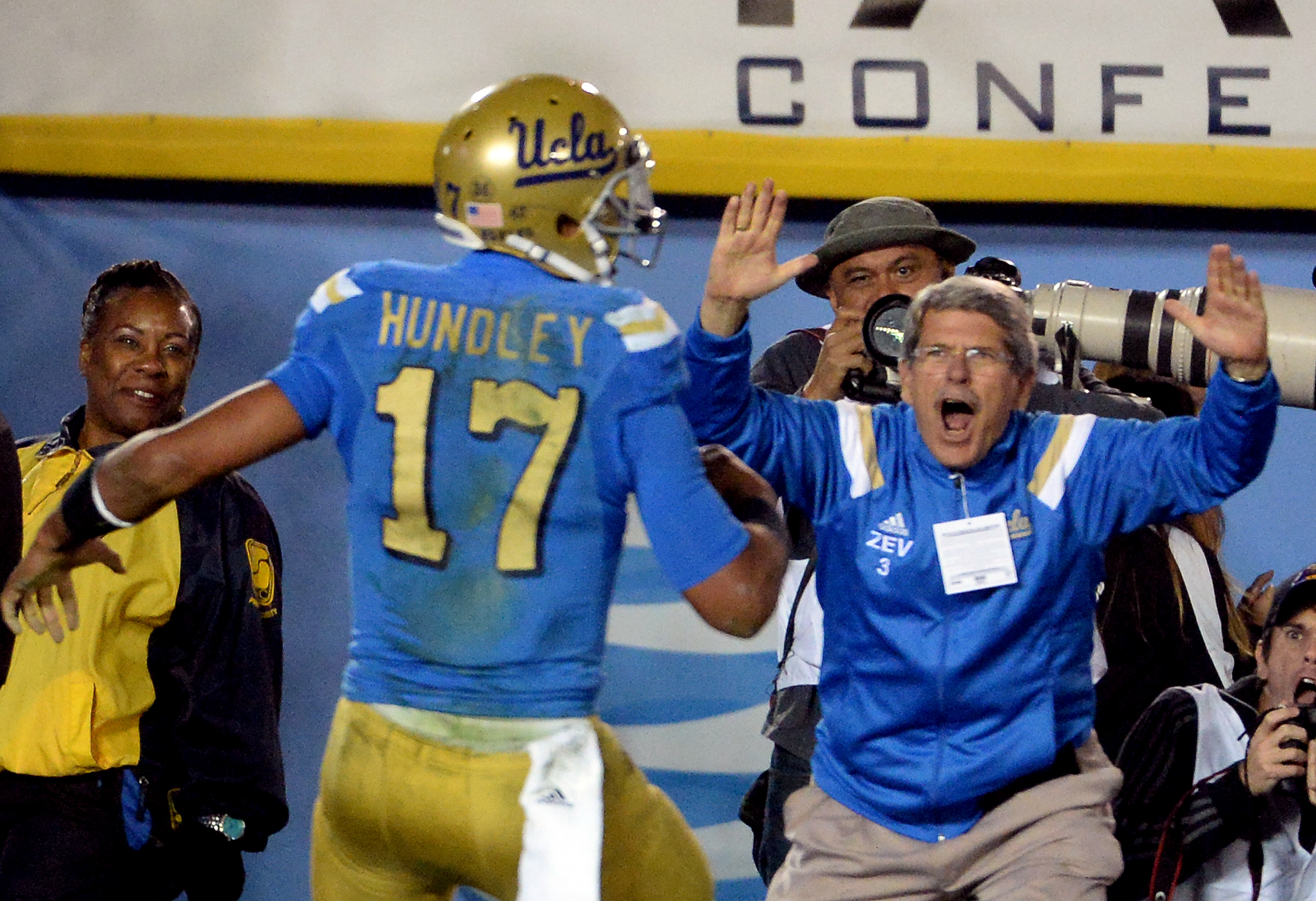 Brett Hundley (17) runs for a touchdown in a 38-20 win over USC, as former Los Angeles County Board of Supervisors Zev Yaroslavsky, right, celebrates at the Rose Bowl on Nov. 22, 2014. (Keith Birmingham/Staff)