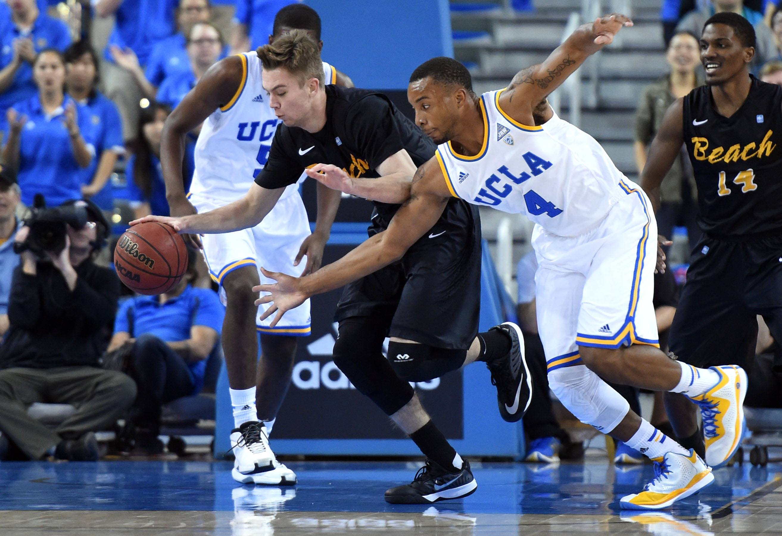 Norman Powell (4) goes for a steal during UCLA's 77-63 win over Long Beach State on Nov. 23. Powell finished the regular season leading the Bruins in points (16.3) and steals (60), and was named to the All-Pac-12 first team. (Stephen Carr/Staff)
