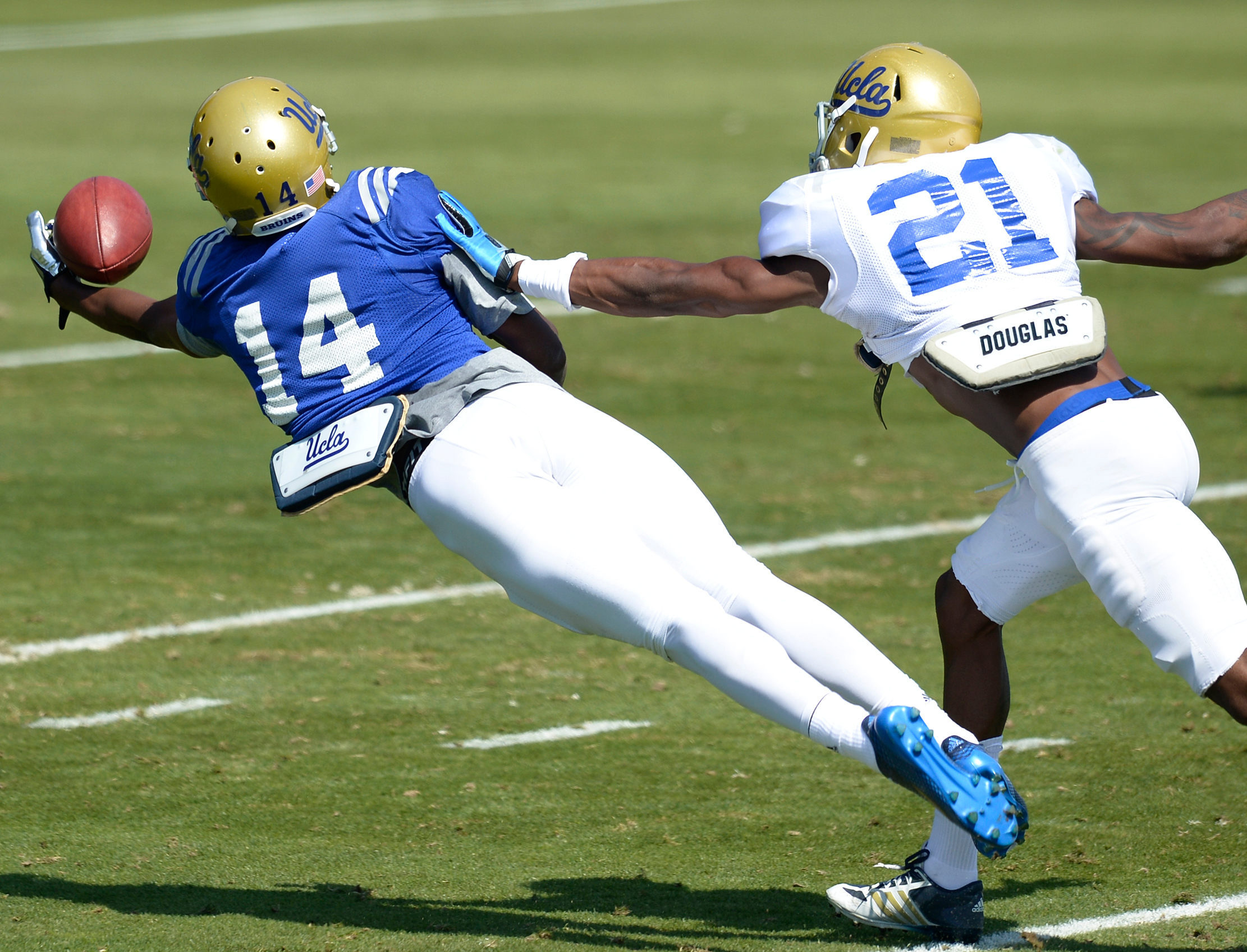 Mossi Johnson pulls in the catch of the practice on a pass from quarterback Asiantii Woulard. (John McCoy/Staff)