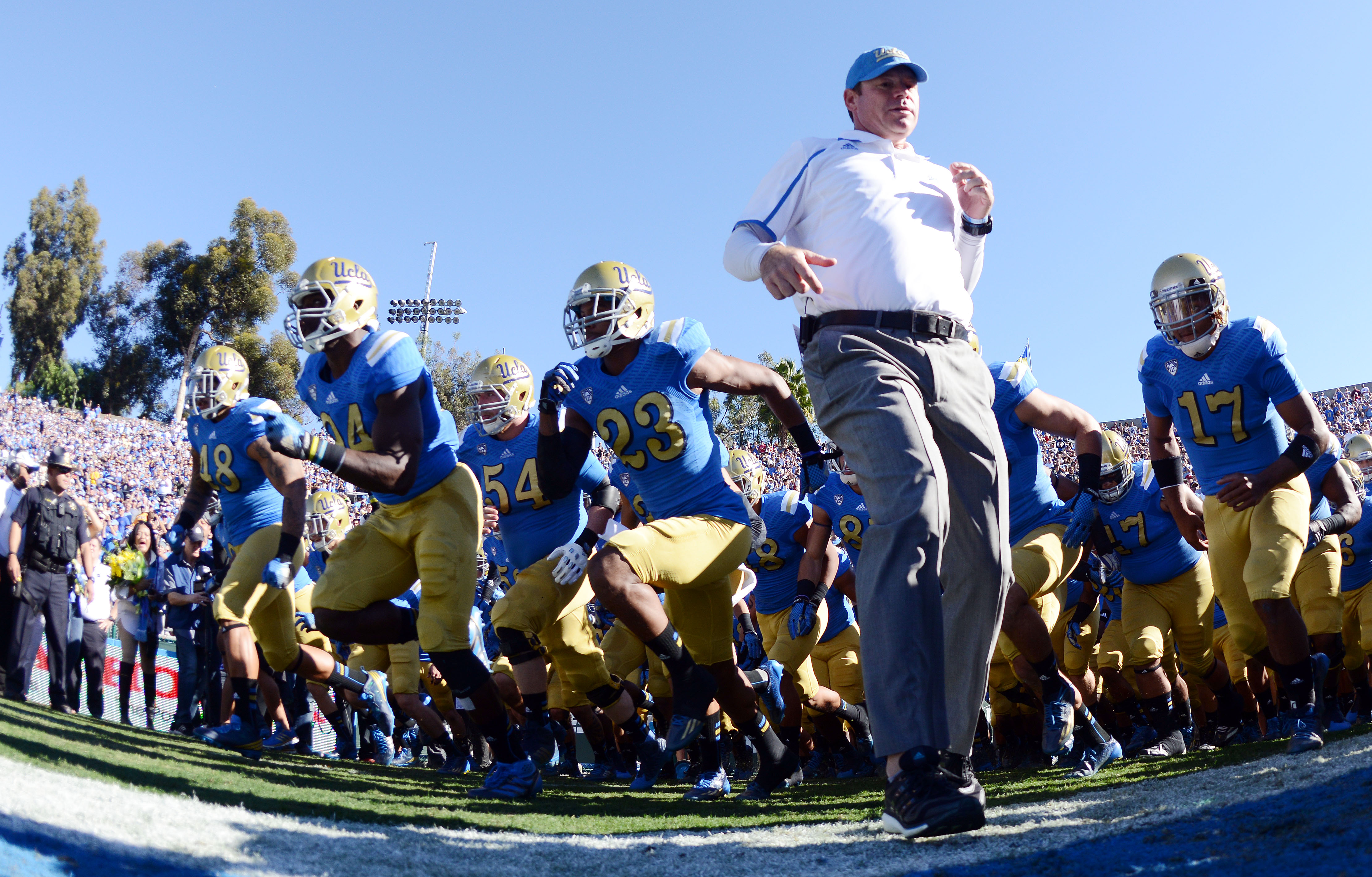 Jim Mora has led UCLA to 29 wins over the past three seasons. He's pictured here as the Bruins run out of the Rose Bowl tunnel against Stanford last November. (Will Lester/Staff)