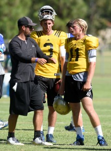 Josh Rosen (3) and Jerry Neuheisel (11) listen to UCLA quarterbacks coach Taylor Mazzone at Cal State San Bernardino on Aug. 12, 2015. (Jennifer Cappuccio Maher/Staff)