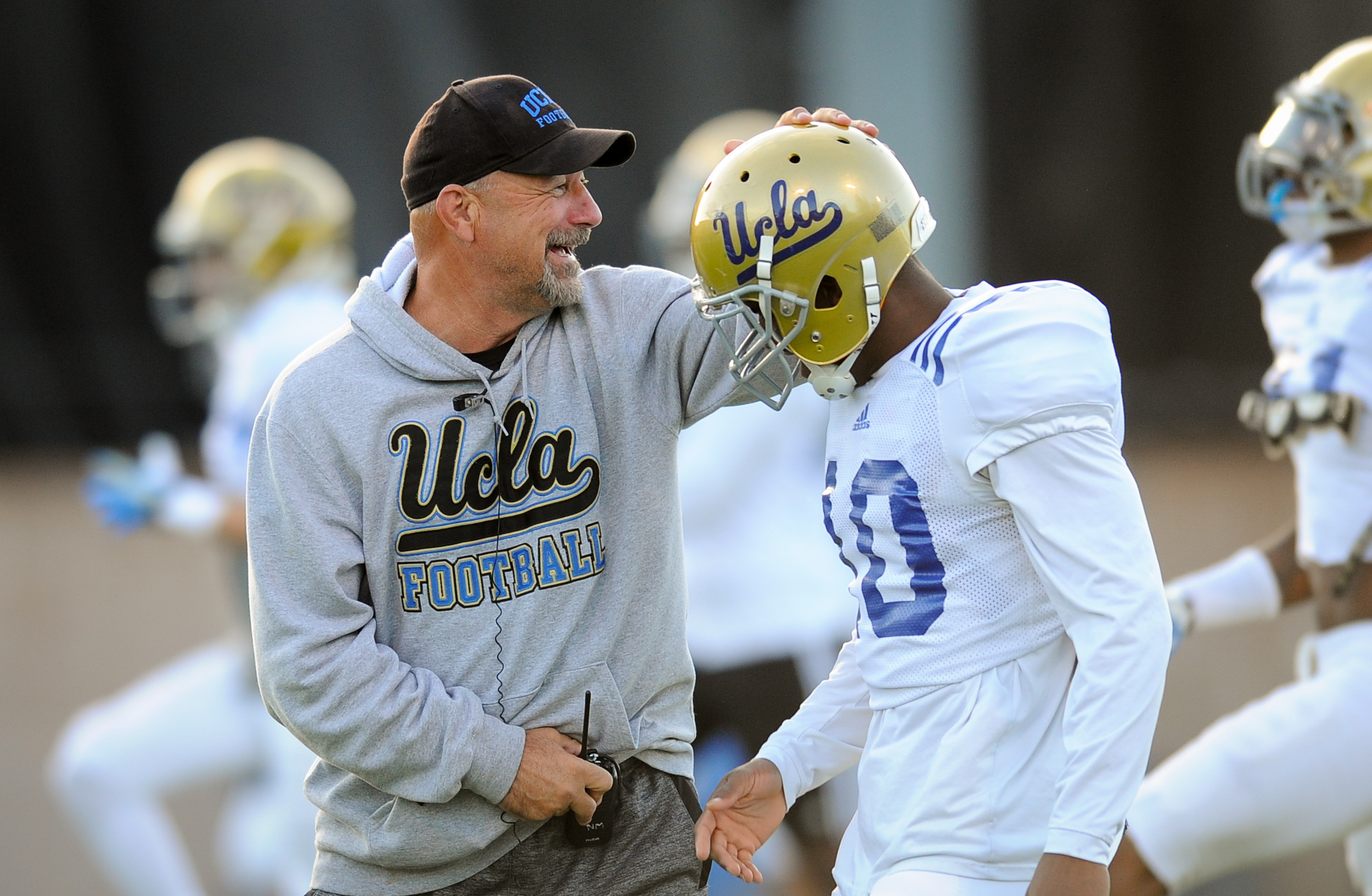 UCLA offensive coordinator Noel Mazzone (left) was the Bruins' highest-paid assistant in 2015, and the second-highest among Pac-12 public schools. (Michael Owen Baker/Staff)