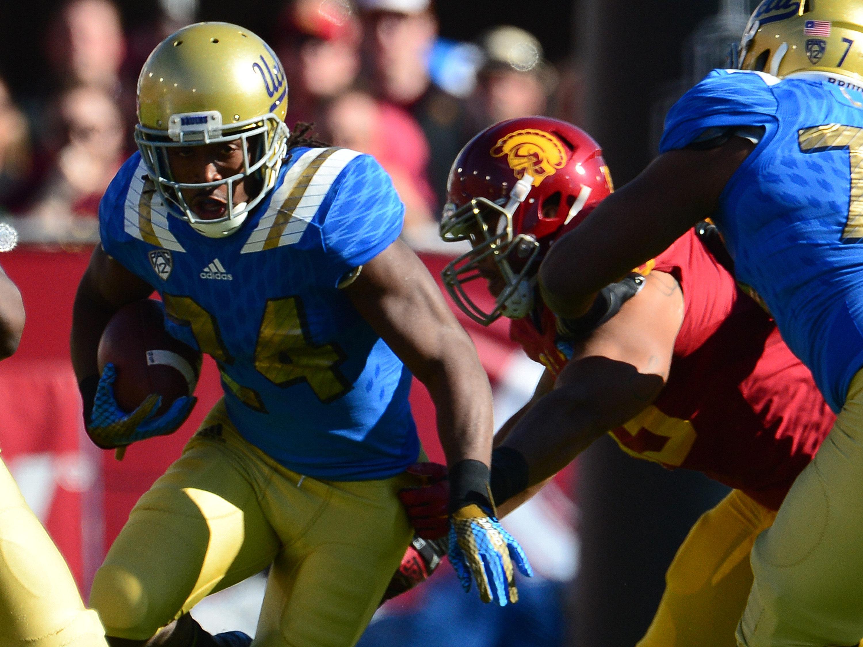 UCLA running back Paul Perkins (24) will enter the 2016 NFL draft, forgoing his final year of eligibility. (Keith Birmingham/Staff)