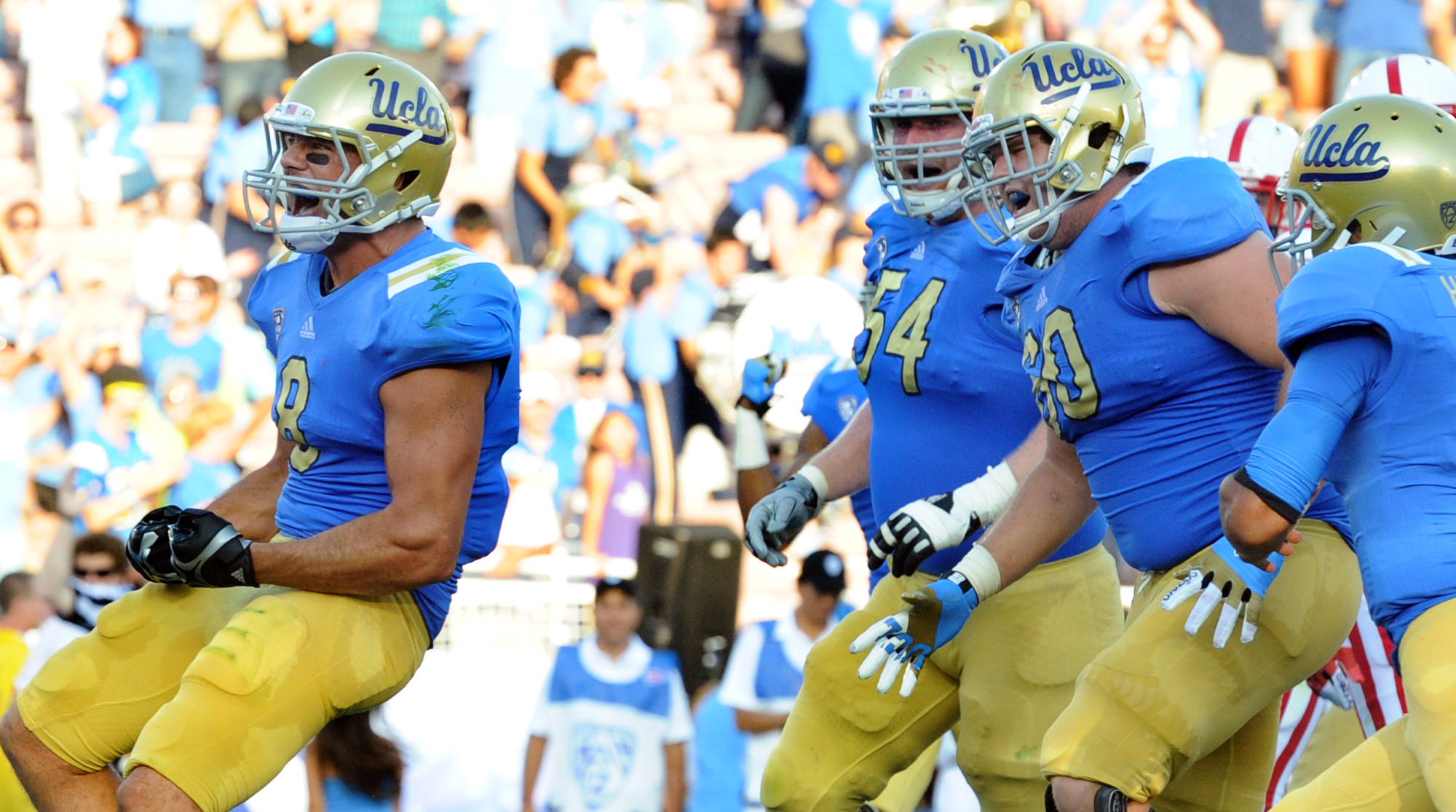 UCLA's 36-30 win over Nebraska in 2012 marked the first big victory of Jim Mora's tenure. Joe Fauria (left) is pictured celebrating one of his two touchdown catches. (Keith Birmingham/Staff)