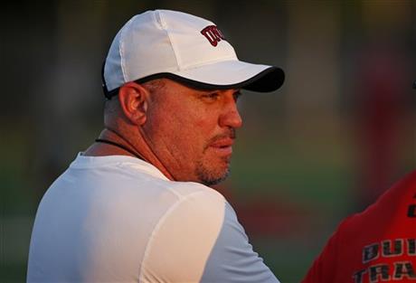 In this Aug. 20, 2015, photo, UNLV head football coach Tony Sanchez speaks with a fellow coach during practice in Las Vegas. Sanchez has made the rare jump directly from coaching high school to a head coach position at a college program. (AP Photo/John Locher)