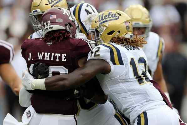 UCLA defensive back Fabian Moreau (10) tackles Texas A&M running back James White (20) for a loss during the first quarter of an NCAA college football game Saturday, Sept. 3, 2016, in College Station, Texas. (AP Photo/Sam Craft) 