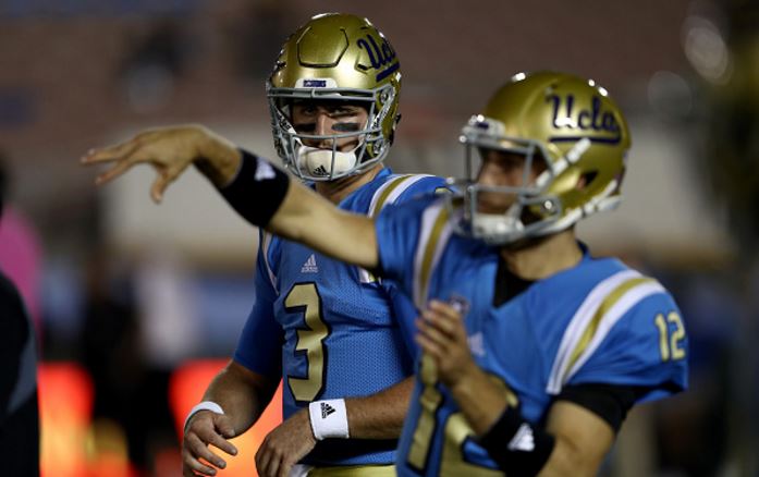 Josh Rosen (behind) and Mike Fafaul warm up before a game against Arizona on Oct. 1. Fafaul has now taken over the starting quarterback position since Rosen's season-ending shoulder surgery. Sean M. Haffey/Getty Images