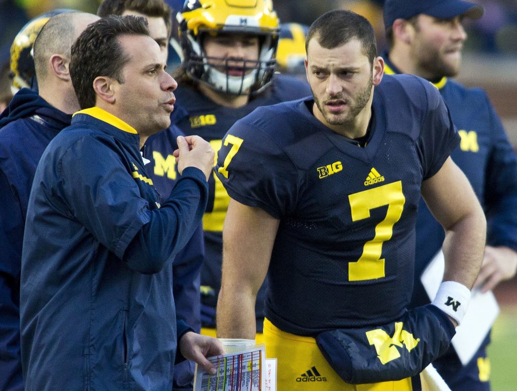FILE - In this April 1, 2016, file photo, Michigan quarterbacks coach Jedd Fisch, left, signals to players on the field form the sideline, watched by Michigan quarterback Shane Morris (7), during the NCAA college football team's annual spring game at Michigan Stadium in Ann Arbor, Mich. Morris, the No. 3 quarterback in the 2013 class according to a 247Sports Composite, has started only two college games and hasn’t thrown a single touchdown pass. (AP Photo/Tony Ding, File)